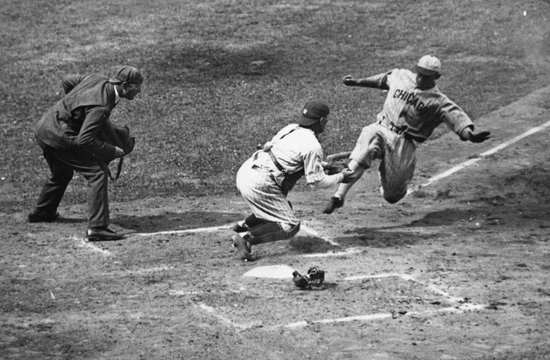 Umpire Gersel, wearing a suit and cap, watches the Chicago White Sox’s Metzler slide on the Yankees in 1932. Image via Getty.